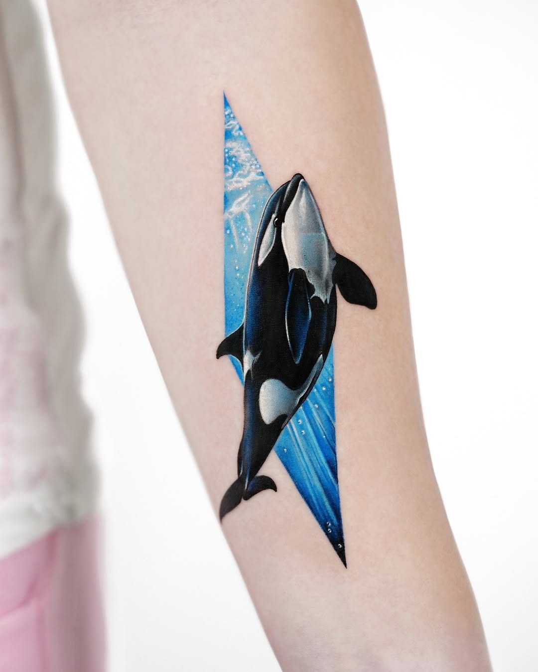 Striking orca tattoo blending with ocean waves Tattoo Design