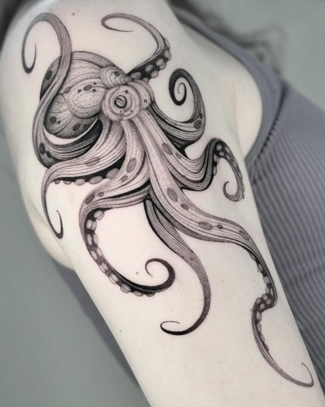 Intricate black ink octopus tattoo on arm Tattoo Design