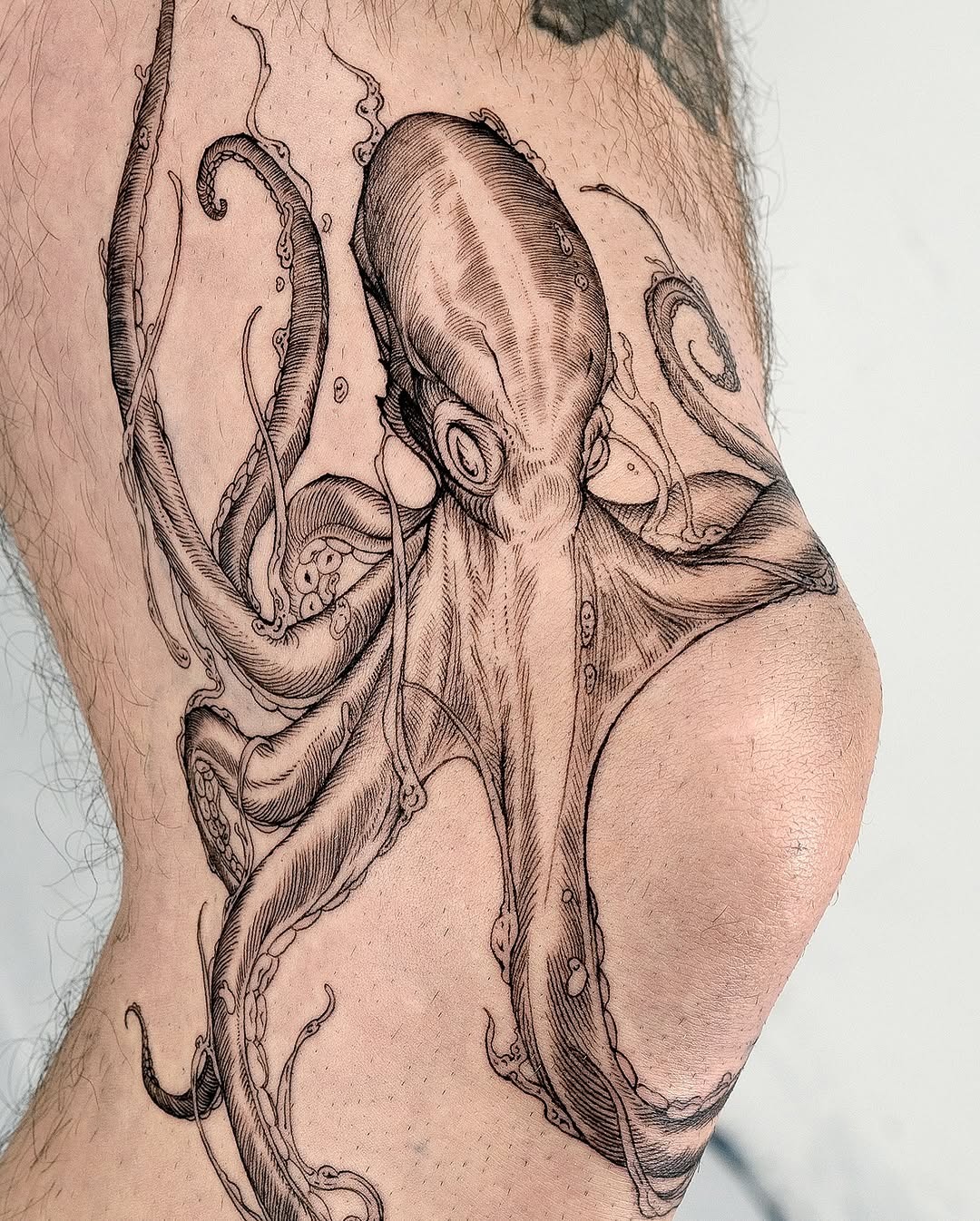 Intricate octopus tattoo wrapped around the thigh Tattoo Design
