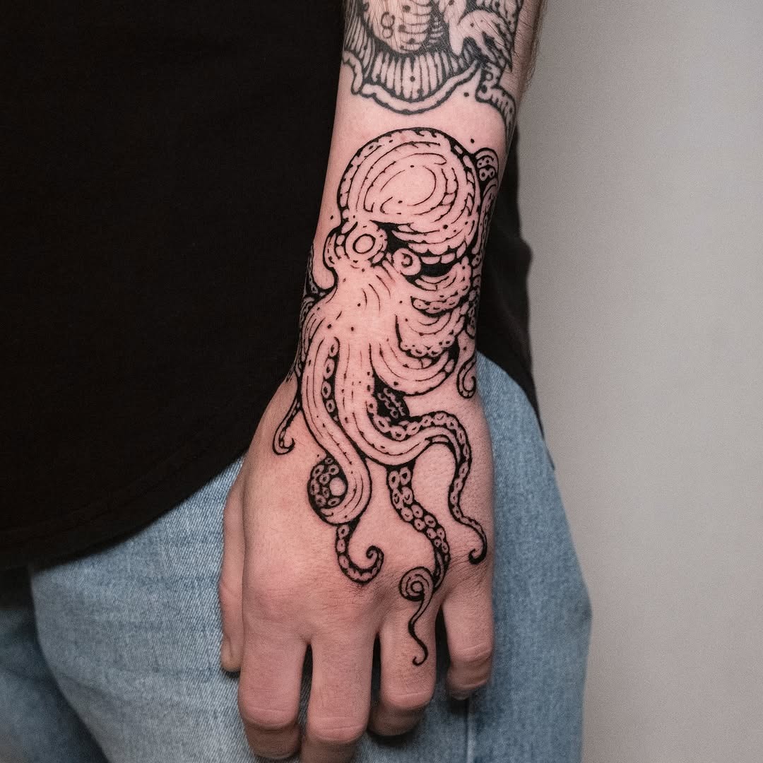 Intricate octopus tattoo wrapping around the arm Tattoo Design