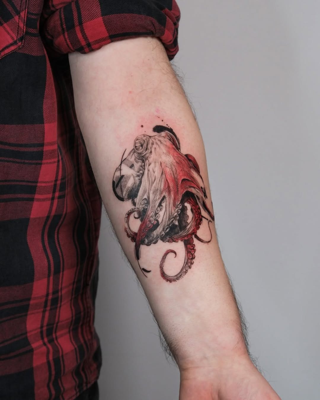 Stunning octopus tattoo with vibrant red details Tattoo Design