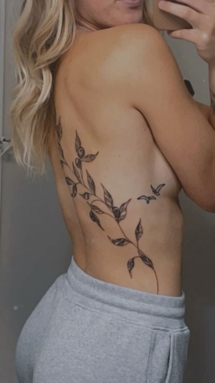 Flowing Olive Branch Down the Back with Tiny Birds, a tattoo design rendered in clean detailed linework.