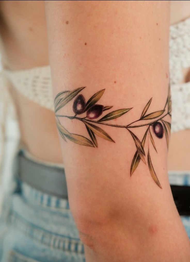 Olive Branch Arm Wrap with Rich Purple Olives, a tattoo design rendered in bold traditional.