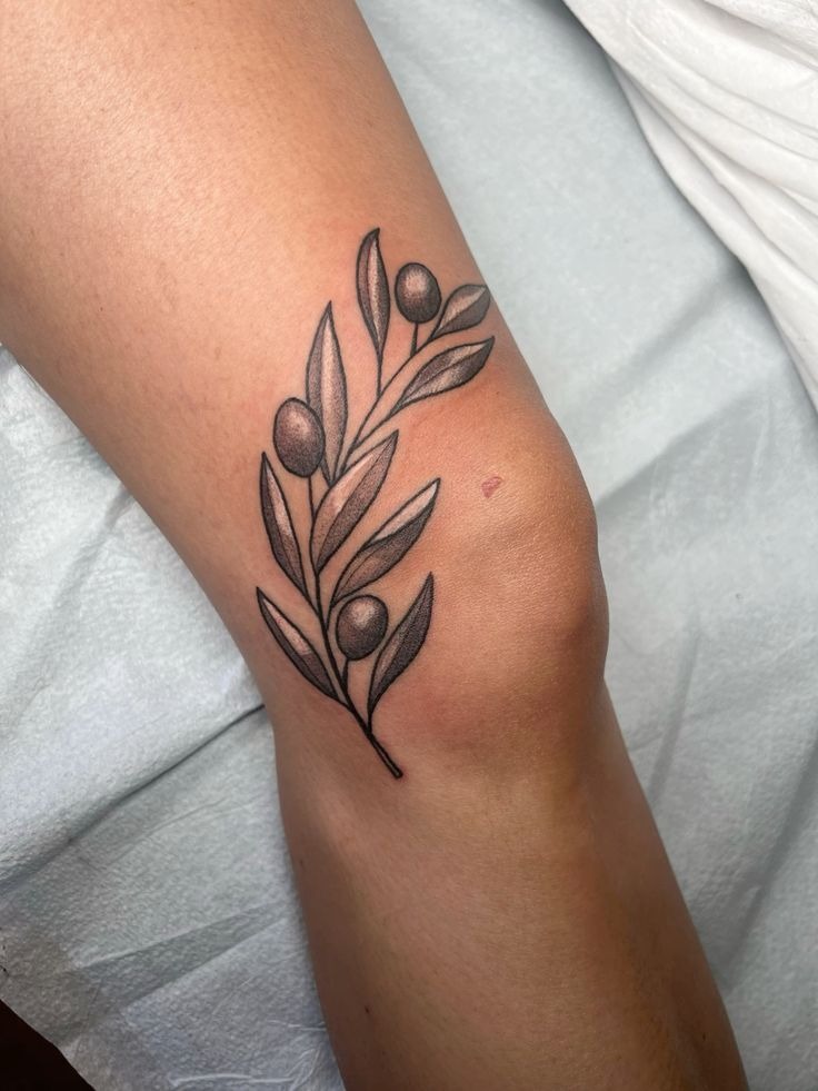 Small Olive Branch Beside the Elbow, a tattoo design rendered in clean detailed linework for the arm.