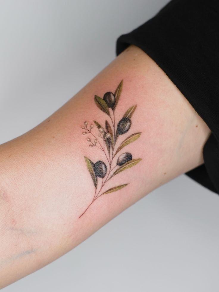 Soft Color Olive Sprig with Tiny Botanical Accent, a tattoo design rendered in bold traditional for the hand.