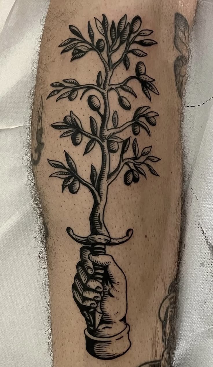 Traditional Olive Tree and Hand Tattoo, a tattoo design rendered in bold traditional.