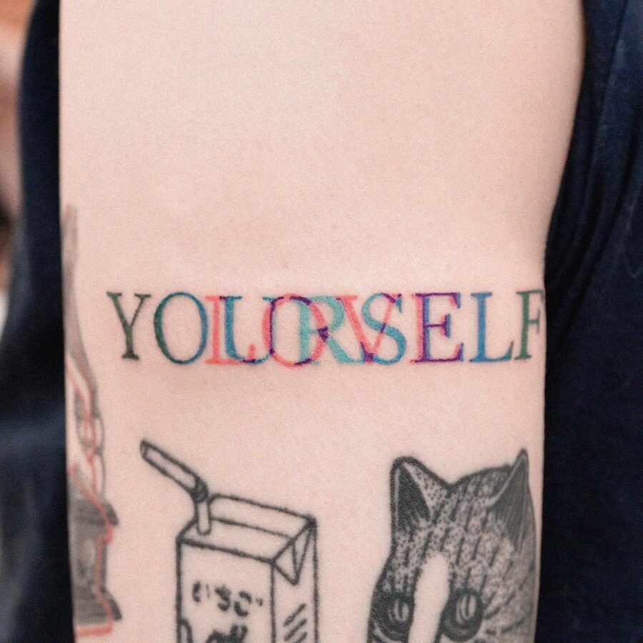 Colorful tattoo emphasizing self-love and identity Tattoo Design