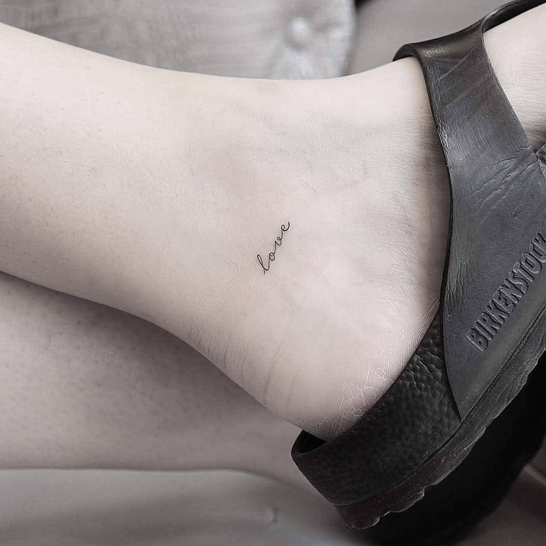 Delicate ankle tattoo showcasing the word 'love' Tattoo Design