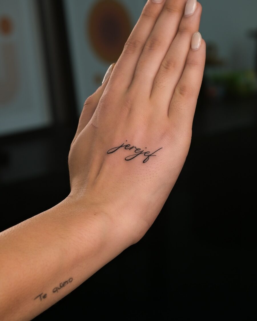 Elegant and minimalist one-word tattoos on hand Tattoo Design