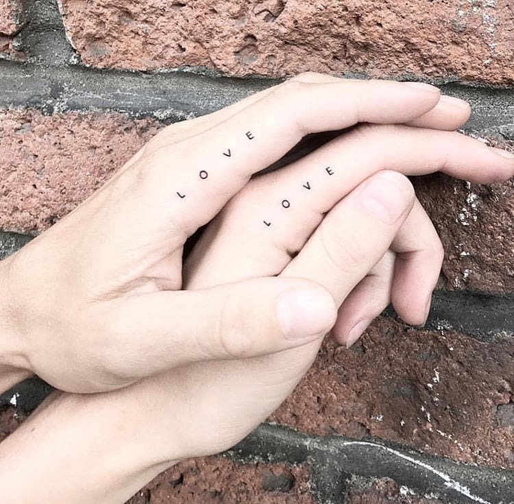 Minimalist LOVE tattoos on couple's hands Tattoo Design