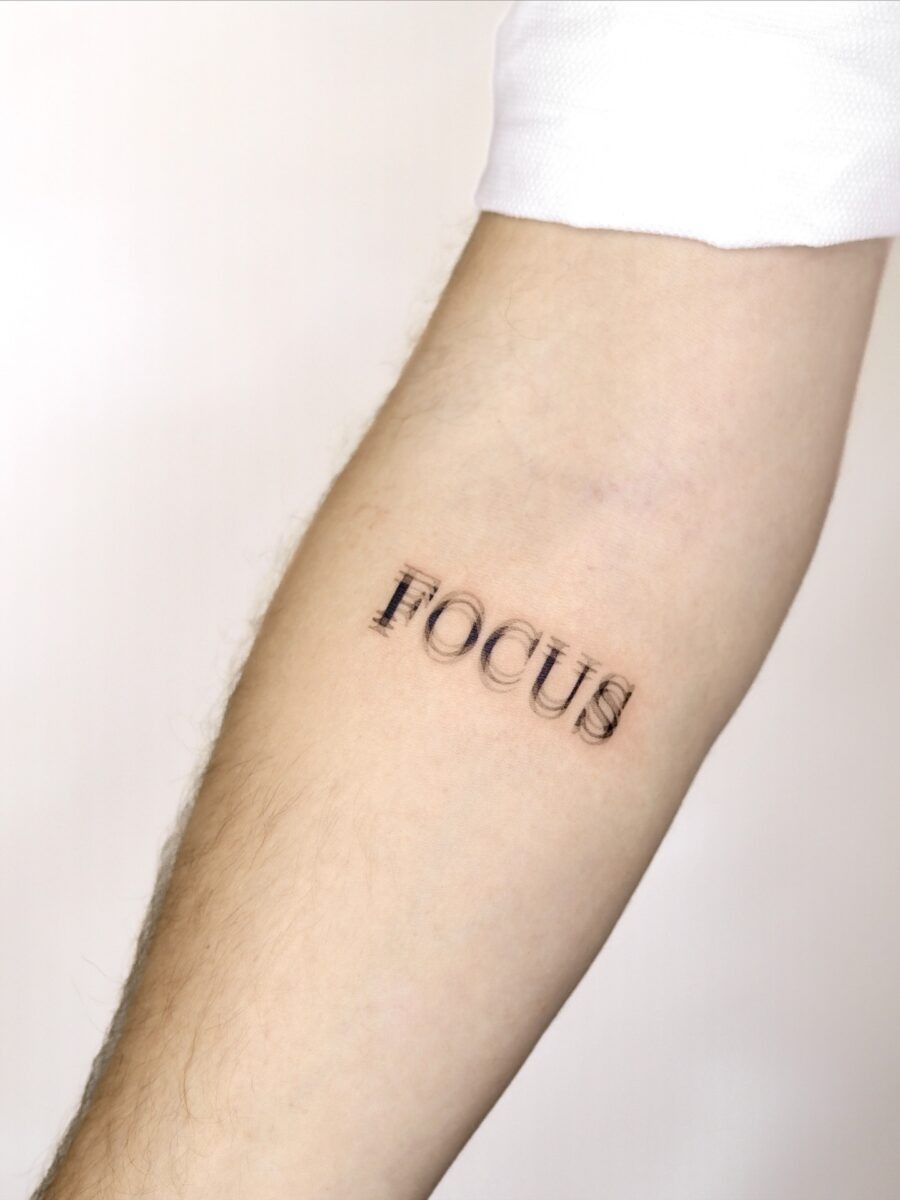 Minimalistic tattoo showcasing the word 'Focus' Tattoo Design
