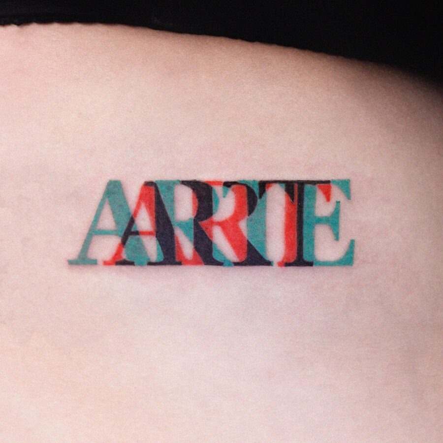 Vibrant one-word tattoo showcasing creativity Tattoo Design