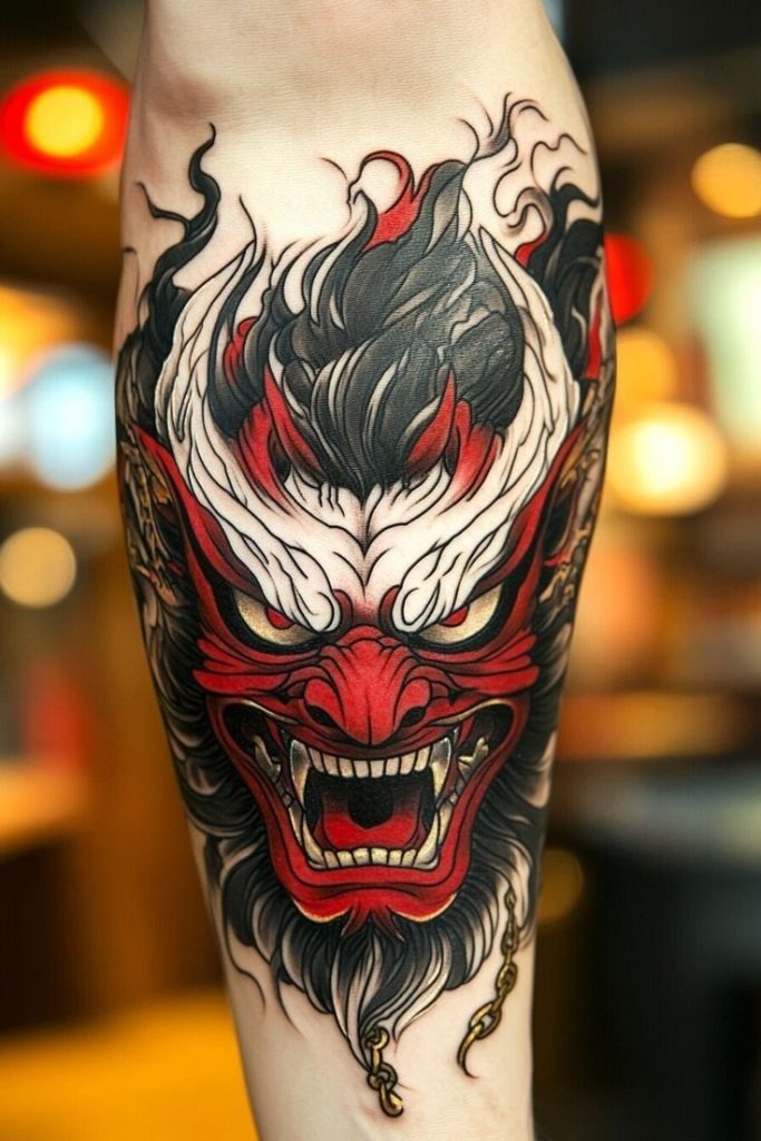 This color tattoo sets the oni mask ablaze with red, black, and ivory flames.