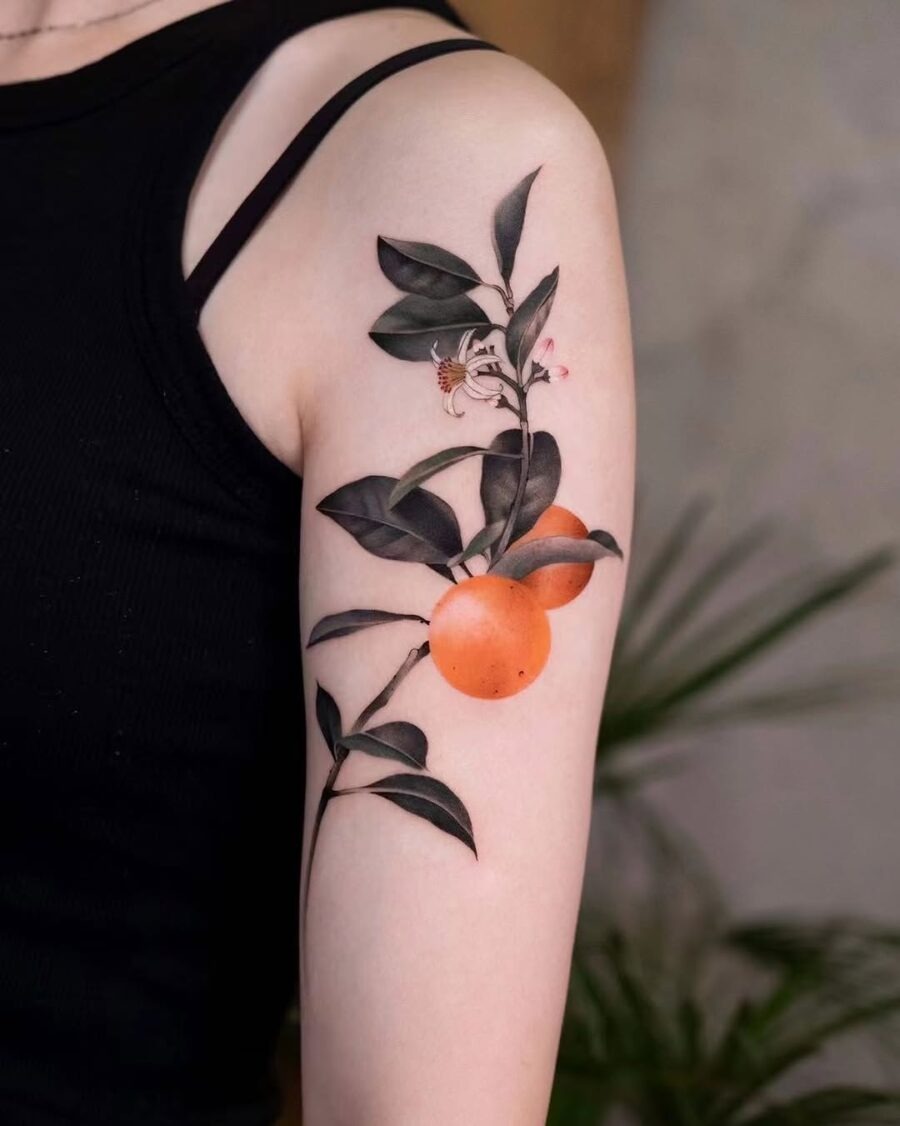 A vibrant orange tattoo surrounded by leaves Tattoo Design