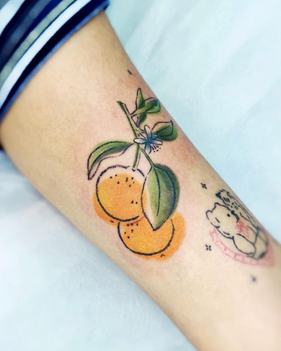 Charming orange tattoo with vibrant leaves Tattoo Design