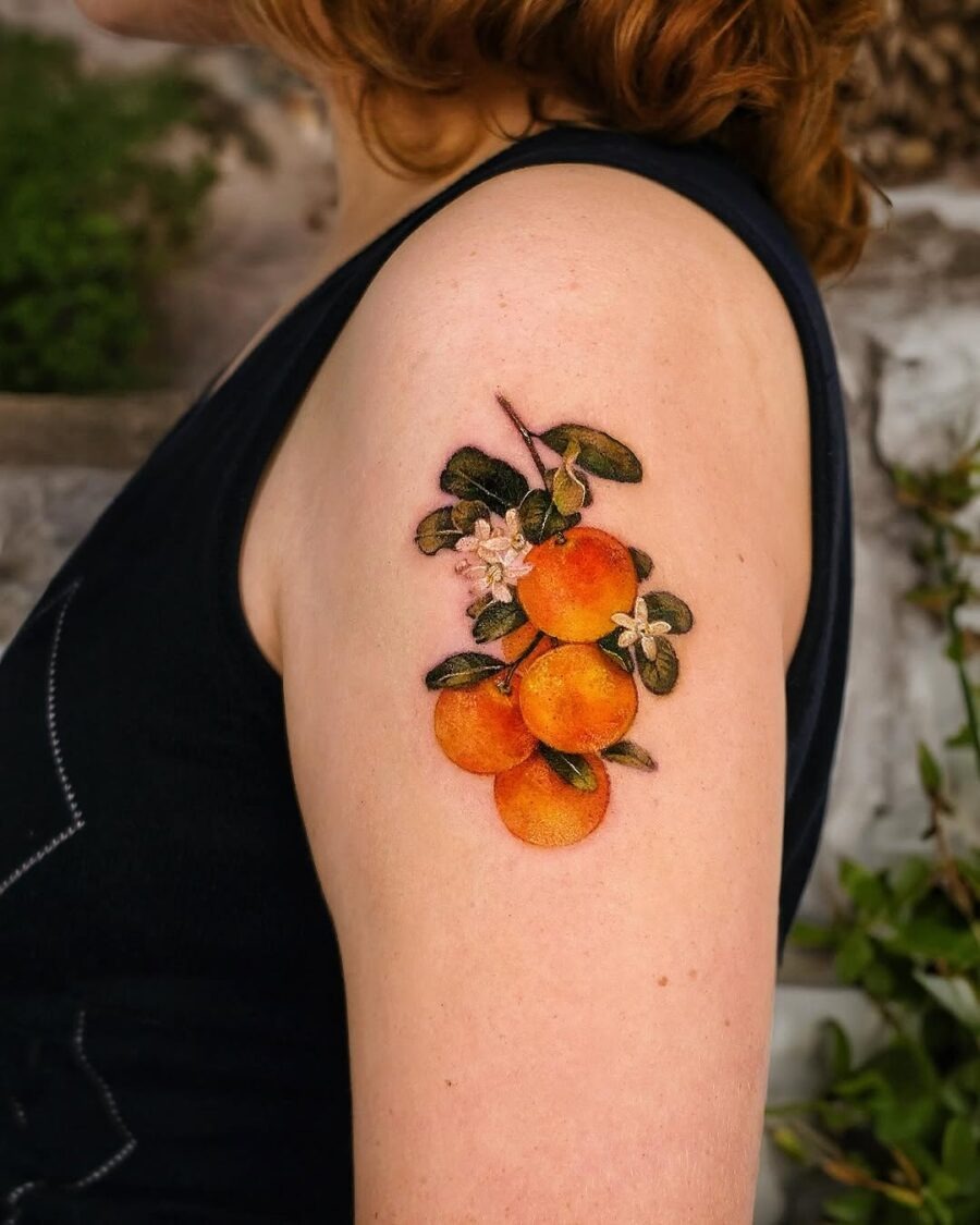 Stunning orange fruit tattoo on arm Tattoo Design