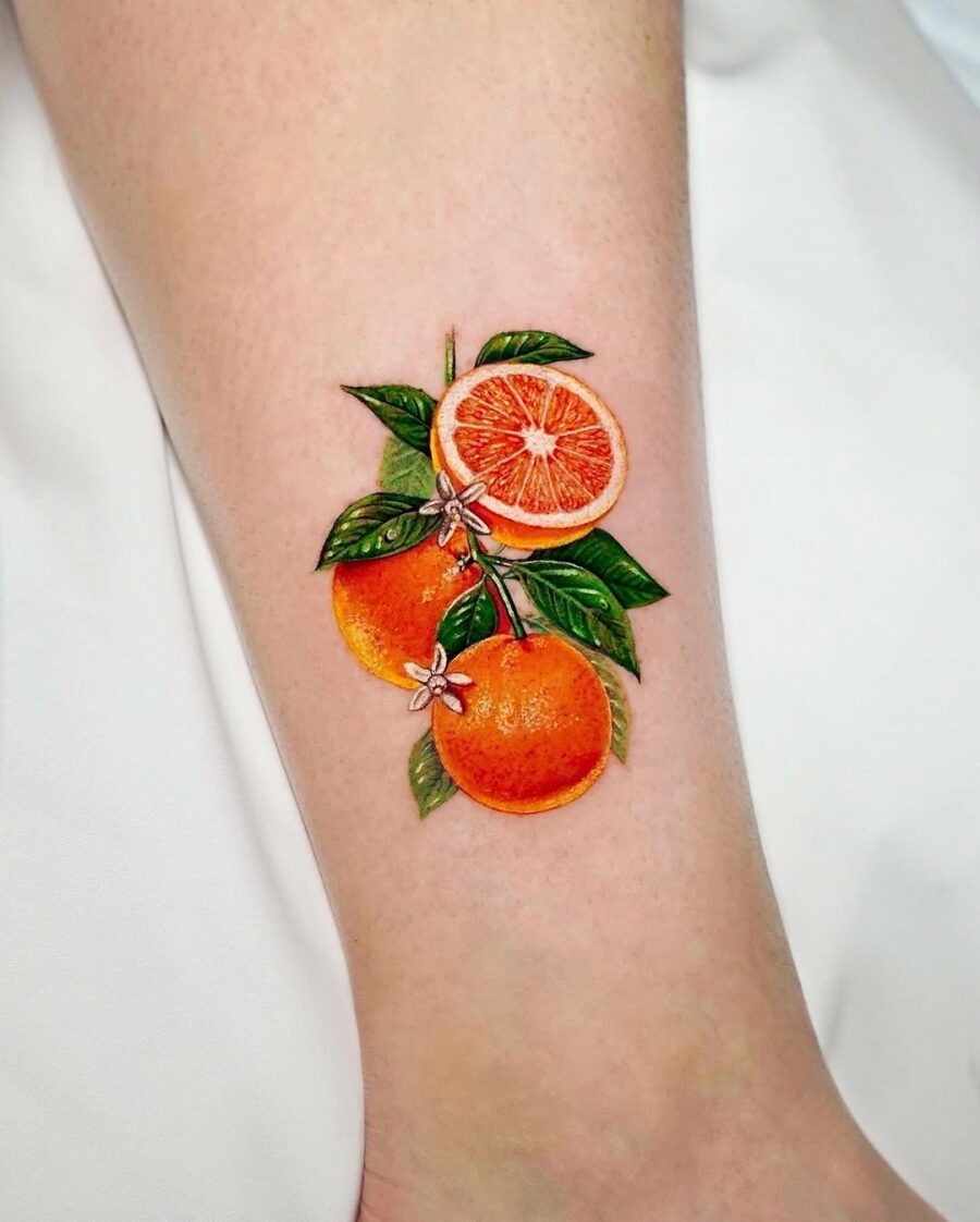 Vibrant Orange Fruit Tattoo with Leaves Tattoo Design