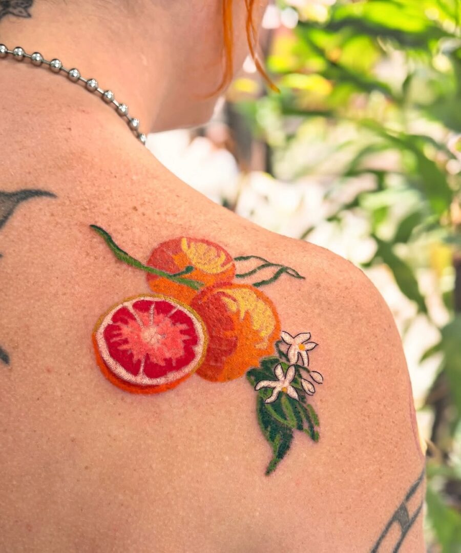 Vibrant orange tattoo with delicate floral accents Tattoo Design
