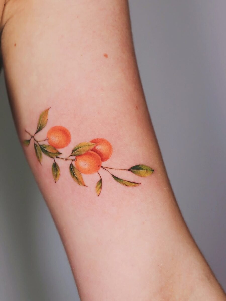 Vibrant orange tattoo with delicate leaves Tattoo Design