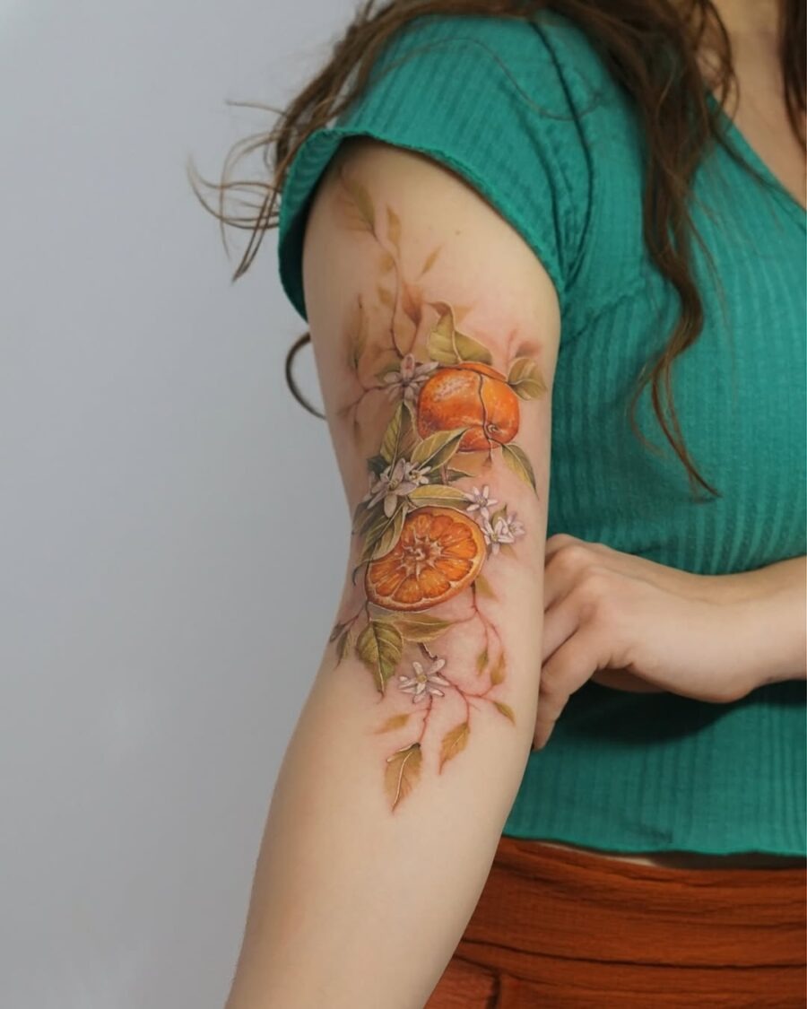 Vibrant orange tattoo with floral accents Tattoo Design
