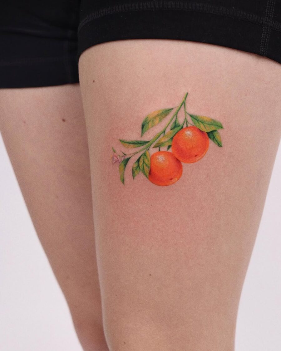 Vibrant orange tattoo with lush green leaves Tattoo Design