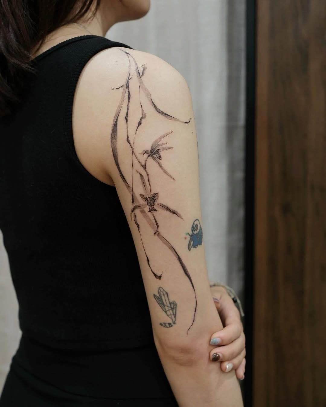 Artistic orchid tattoo on a woman’s arm Tattoo Design