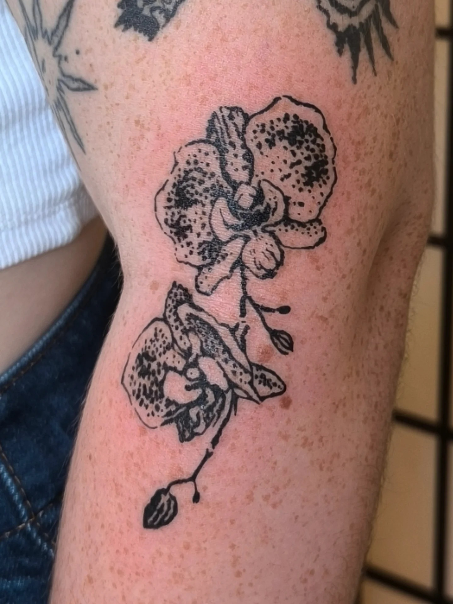 Delicate black orchid design on the arm Tattoo Design