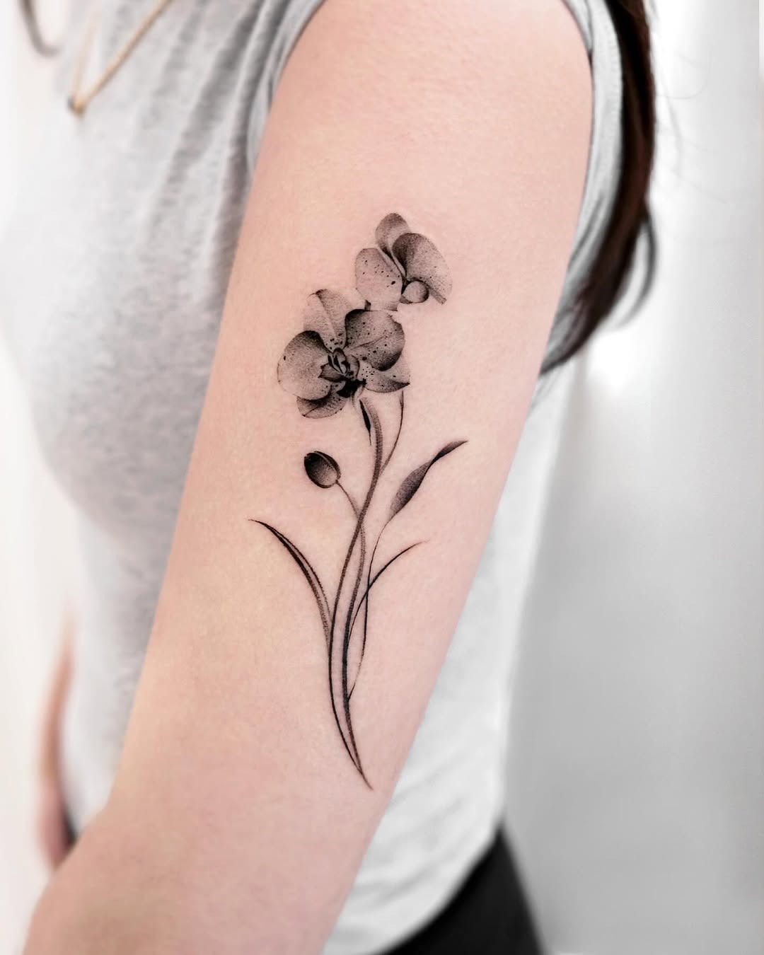 Elegant black and gray orchid tattoo on arm Tattoo Design