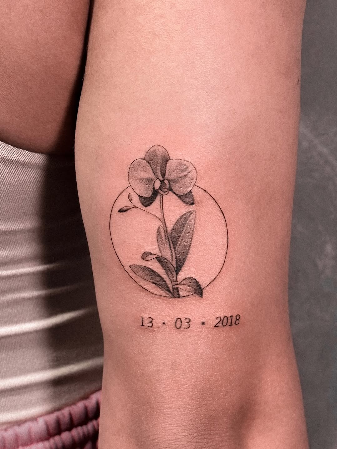 Elegant minimalistic orchid tattoo with date Tattoo Design
