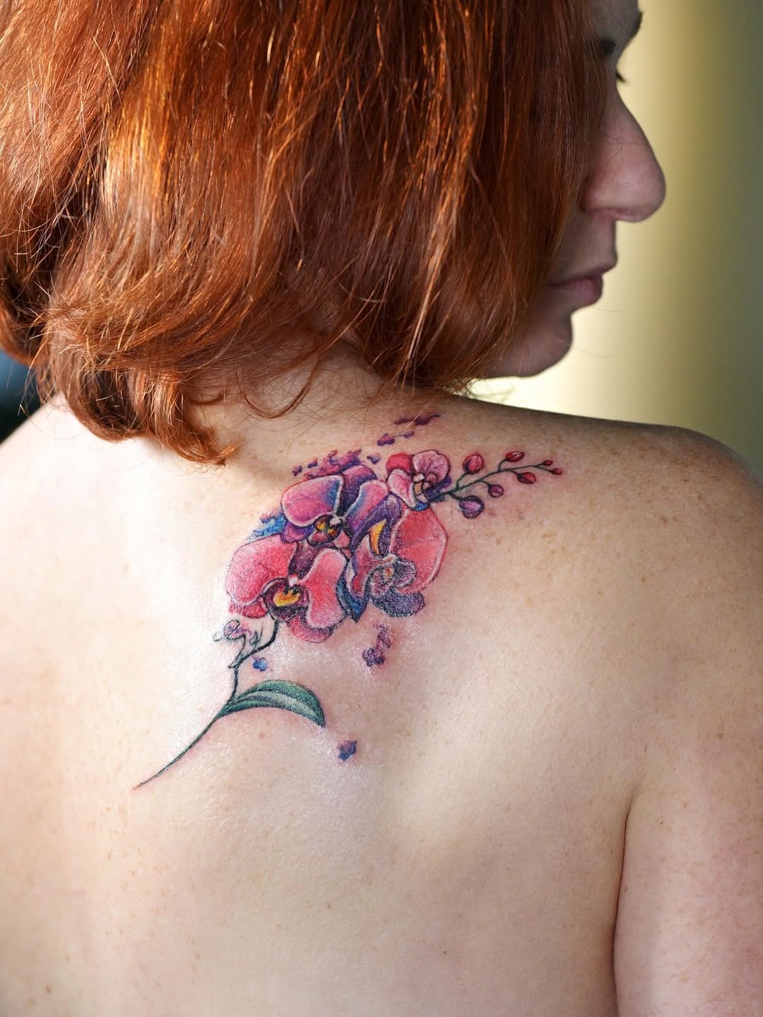 Elegant orchid tattoo design on shoulder blade Tattoo Design
