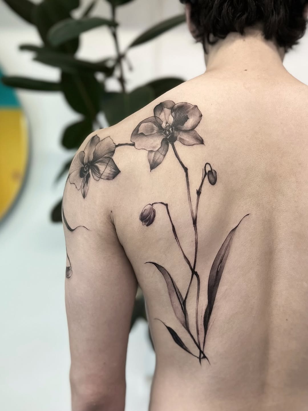 Elegant orchid tattoo on the back Tattoo Design