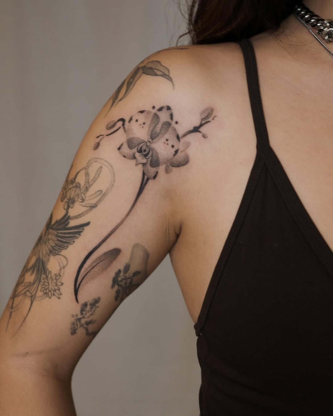 Elegant orchid tattoo on the shoulder Tattoo Design