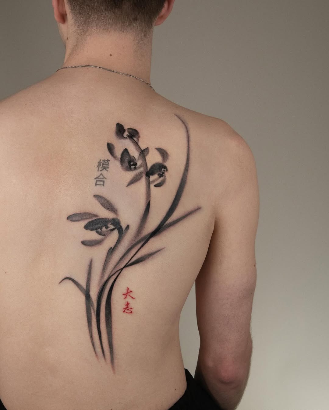 Elegant orchid tattoo with bold black ink. Tattoo Design