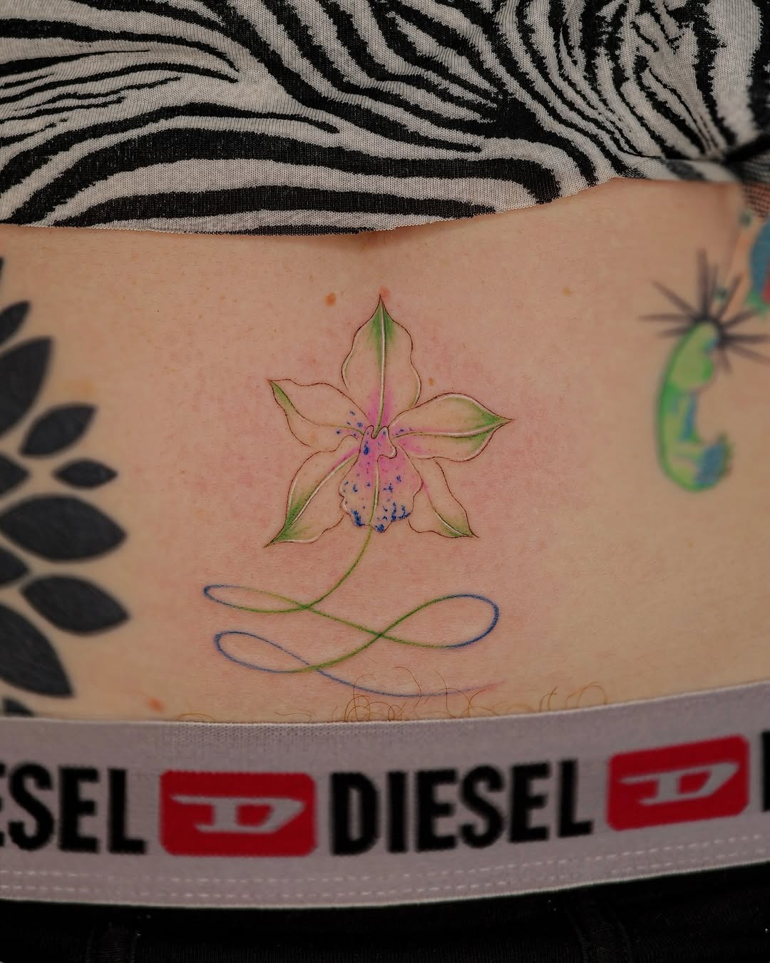 Elegant orchid tattoo with delicate lines. Tattoo Design