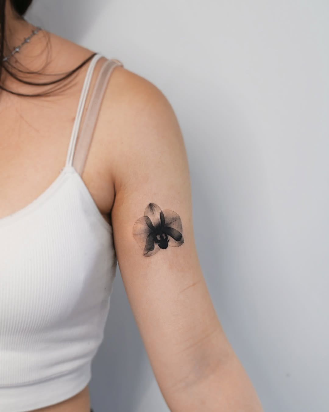 Stunning black orchid tattoo on the arm Tattoo Design