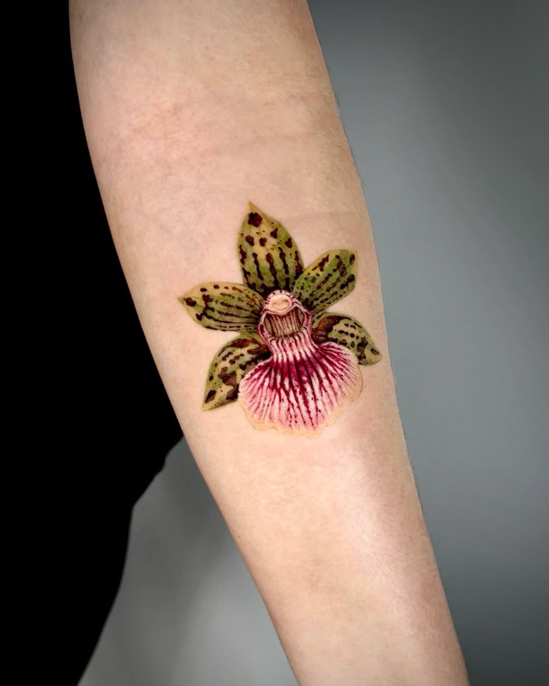 Stunning orchid tattoo showcasing elegant floral artistry Tattoo Design