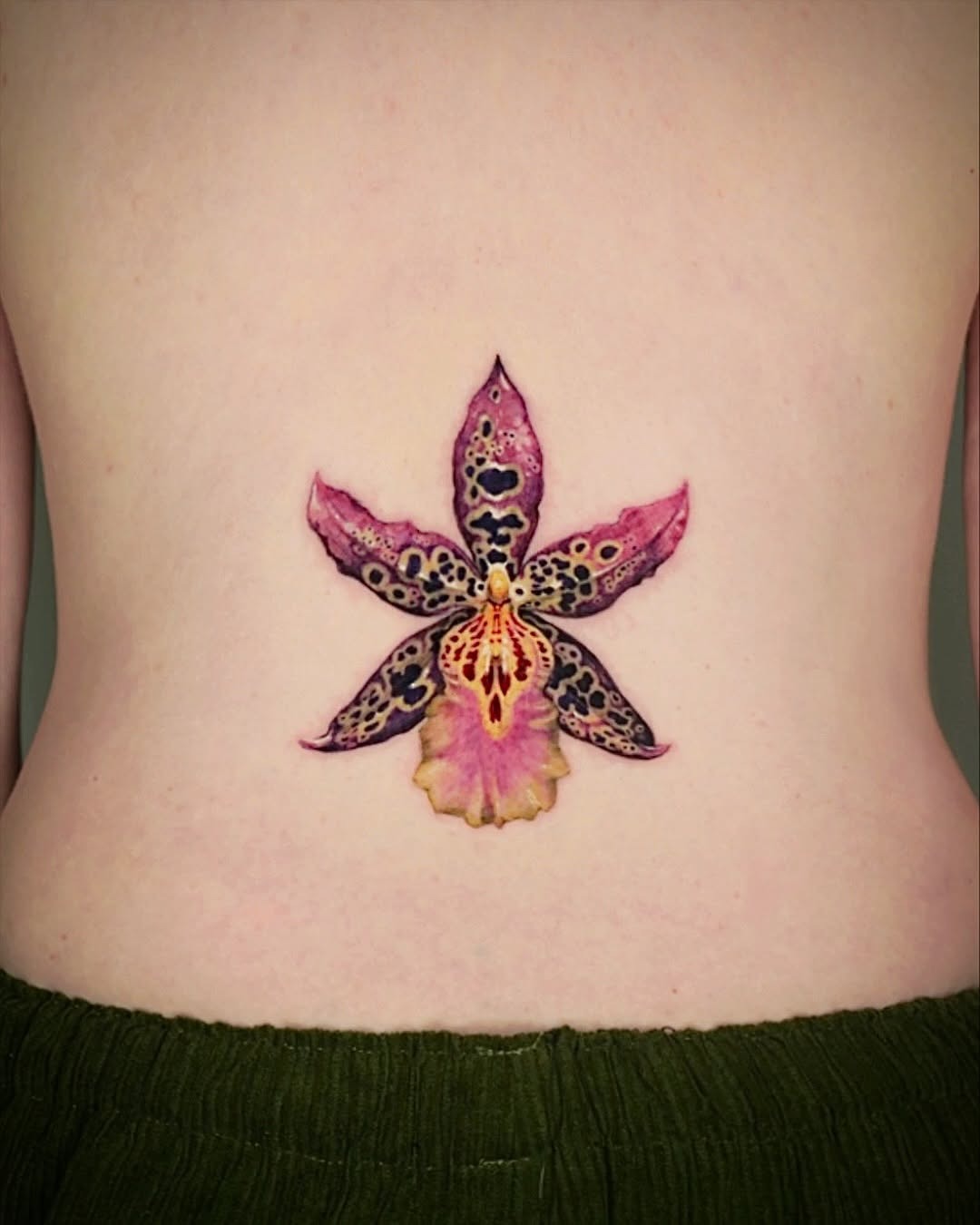 Stunning watercolor orchid tattoo design on back Tattoo Design