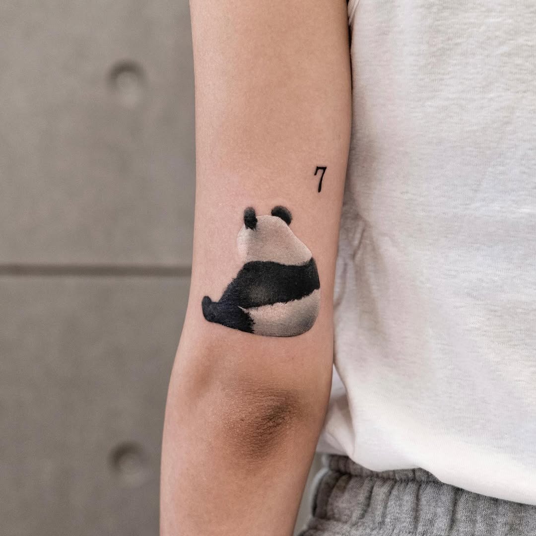 Charming minimalist panda tattoo design on arm Tattoo Design