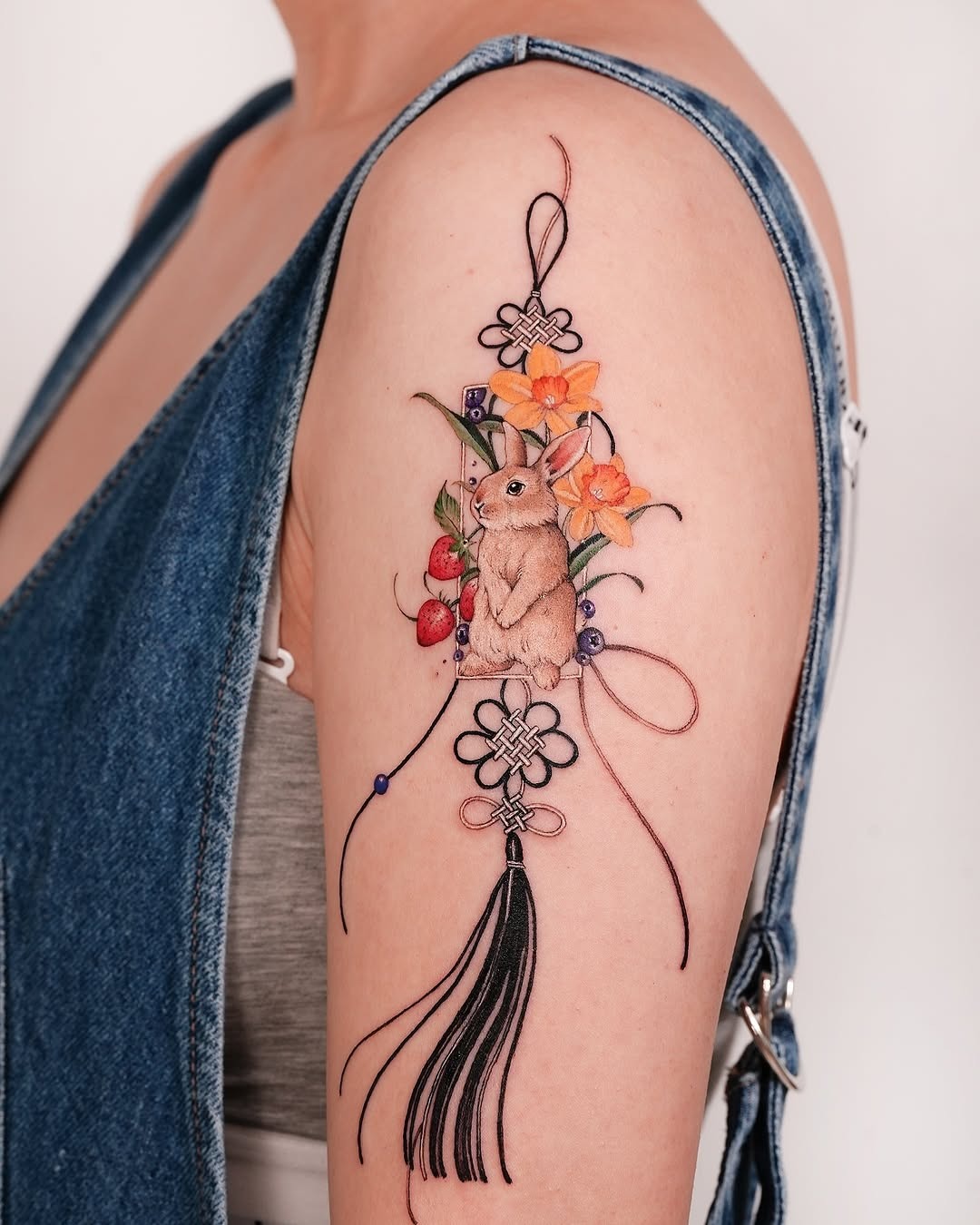 Charming rabbit surrounded by vibrant floral elements Tattoo Design