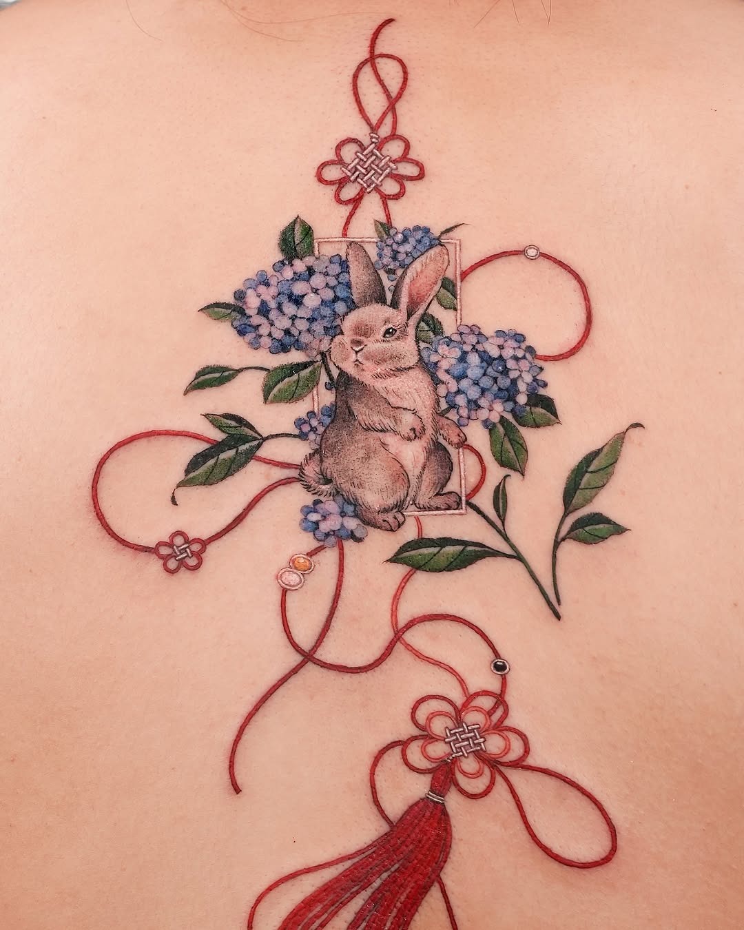 Charming rabbit tattoo amidst vibrant flowers Tattoo Design
