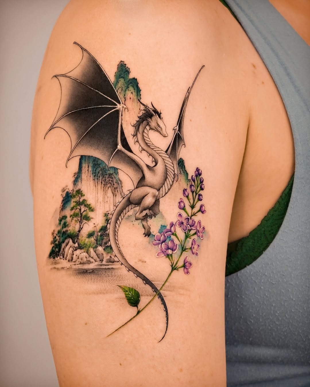 Elegant Dragon Tattoo with Floral Accents Tattoo Design