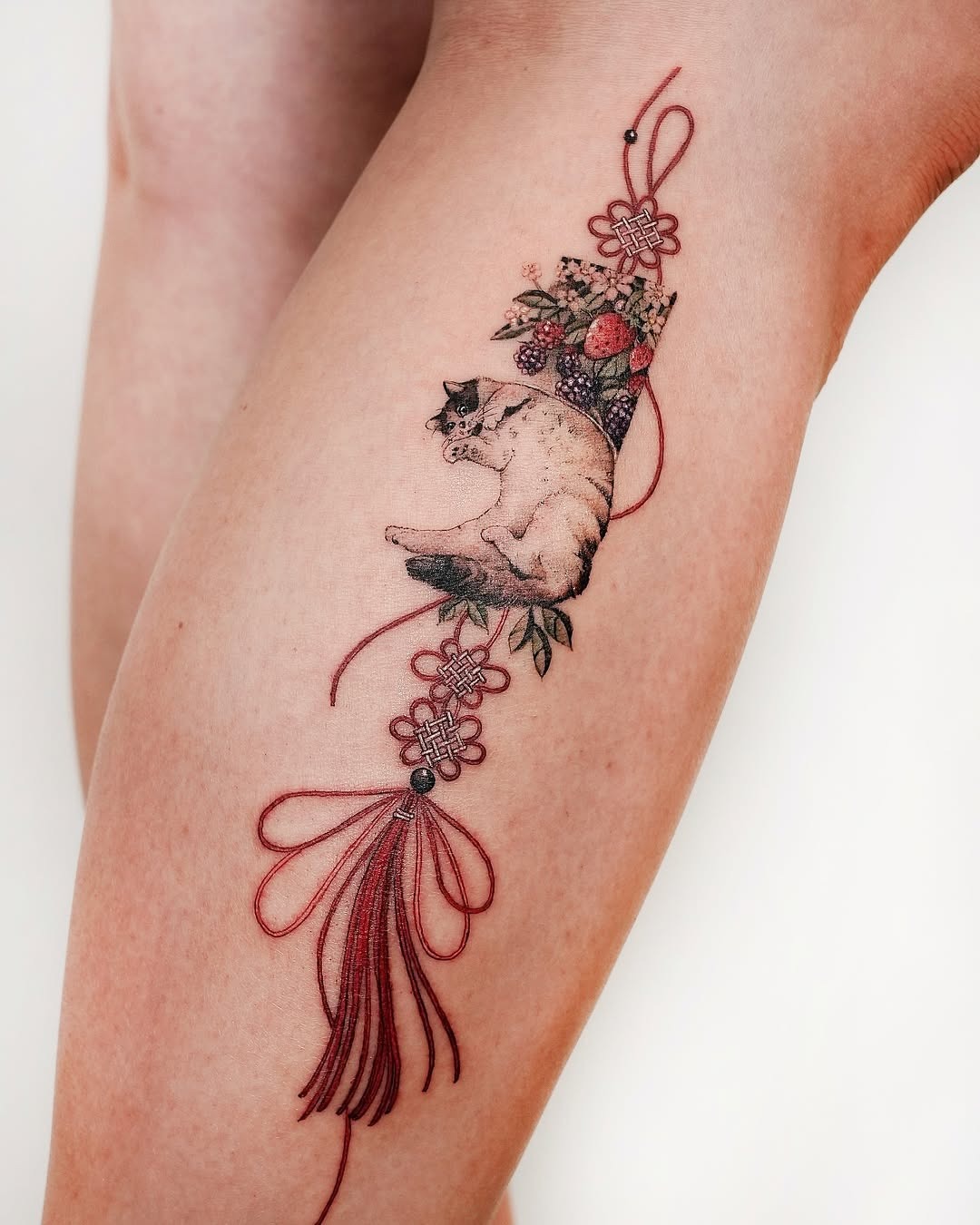 Elegant Oriental Cat Tattoo with Floral Accents Tattoo Design