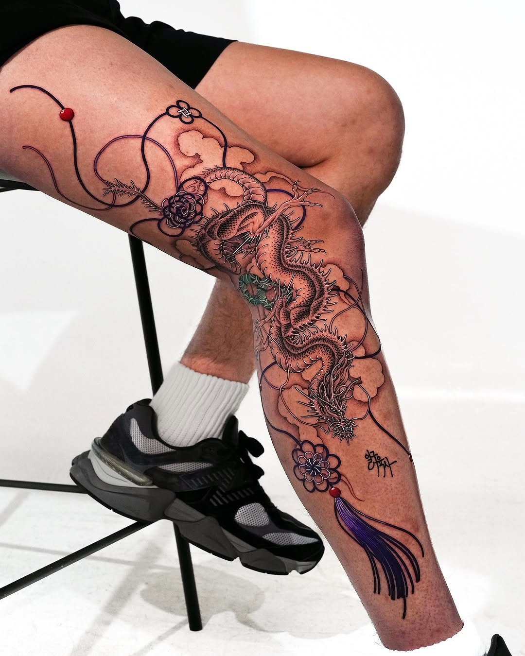 Intricate dragon tattoo adorned with floral motifs Tattoo Design