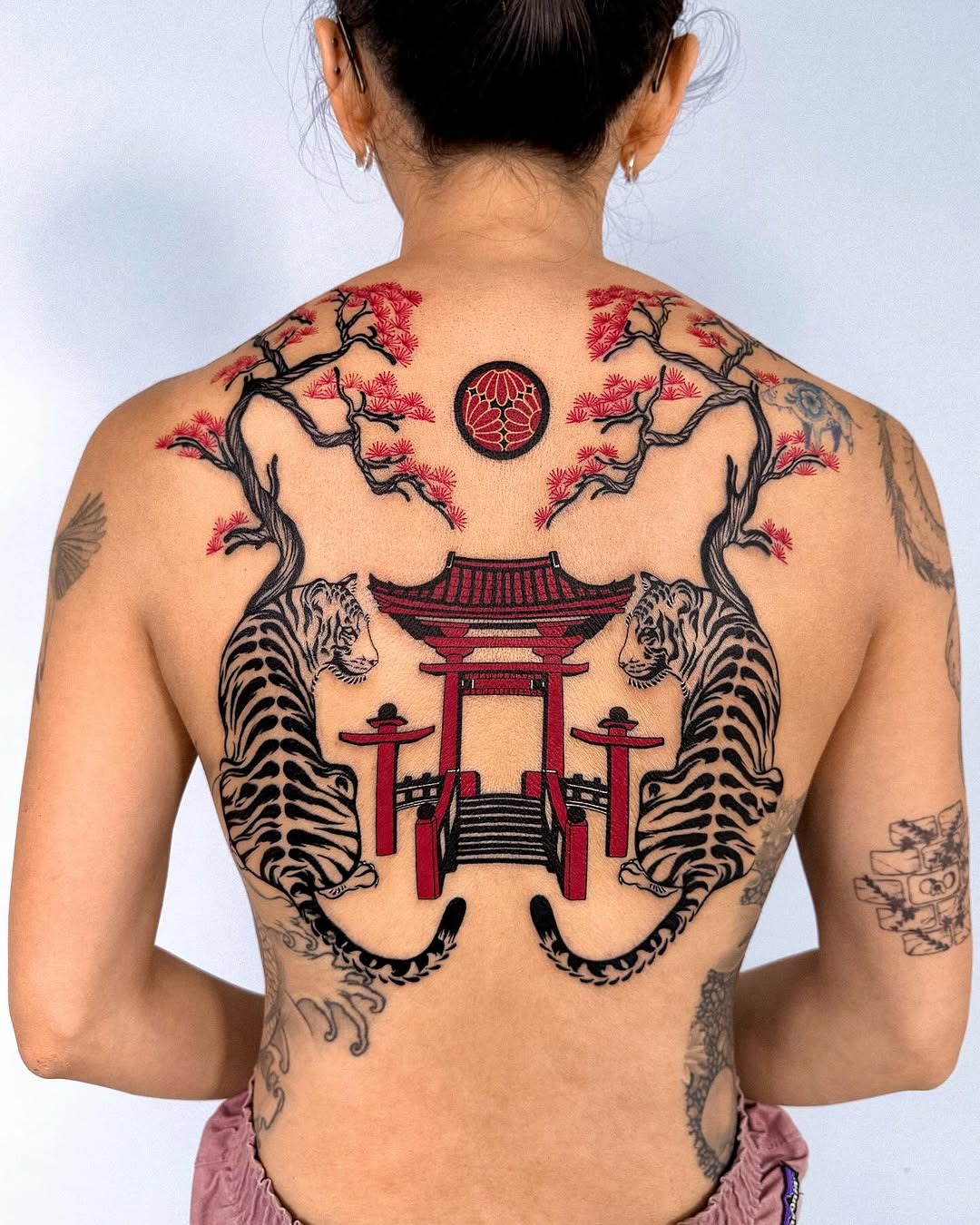 Striking Back Tattoo Featuring Tigers and Pagoda Tattoo Design