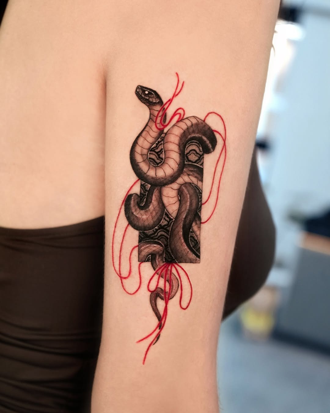 Striking snake tattoo with bold red accents Tattoo Design