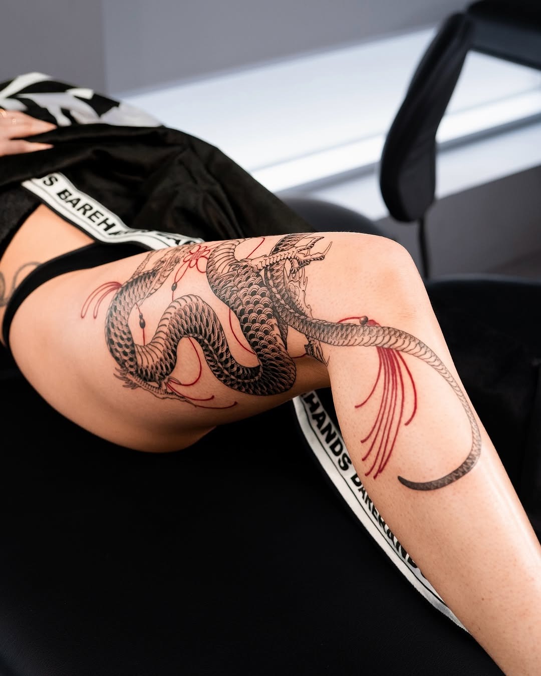 Stunning dragon tattoo wrapping the leg elegantly Tattoo Design