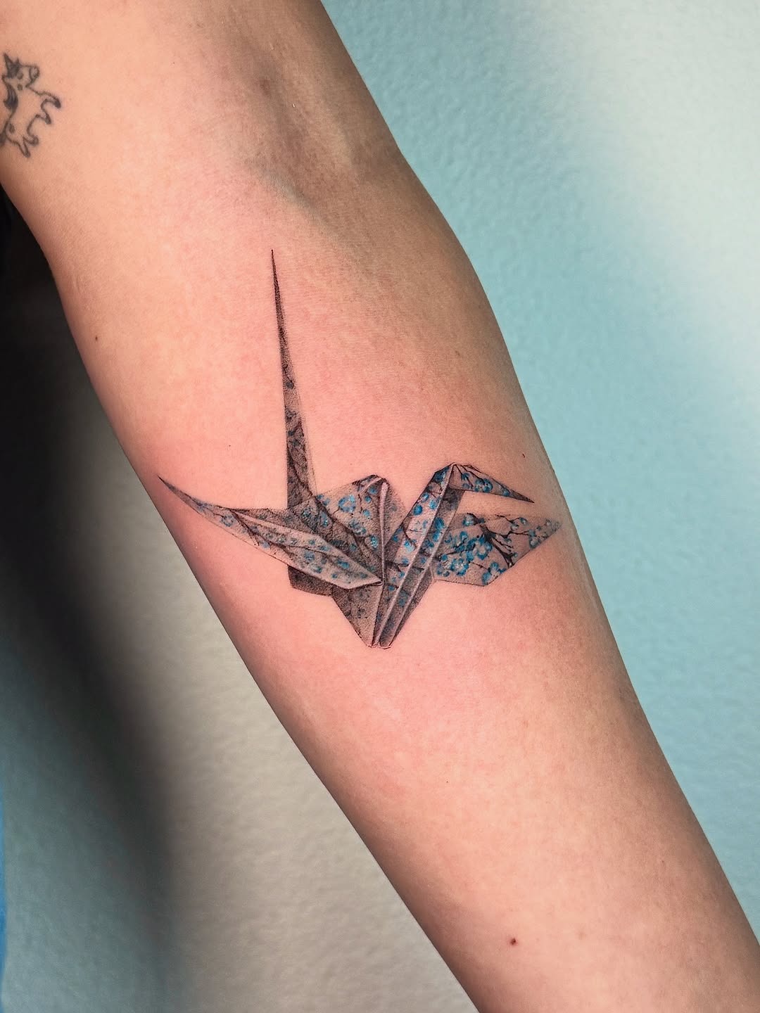 Beautiful origami crane tattoo with watercolor hues Tattoo Design