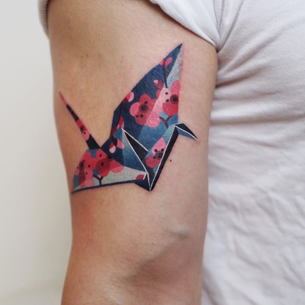 Colorful origami crane tattoo with floral elements Tattoo Design