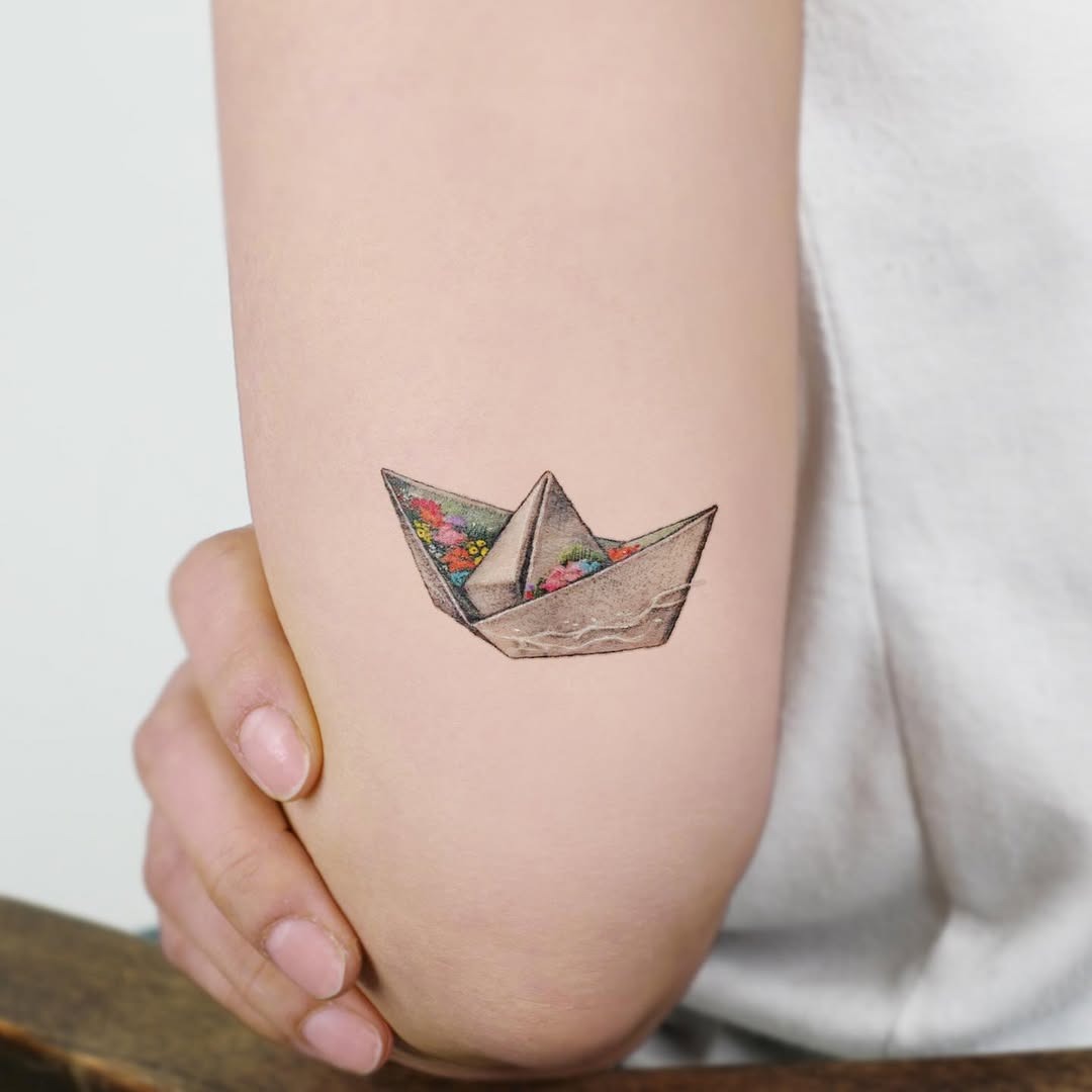Elegant Origami Boat Tattoo with Floral Touch Tattoo Design