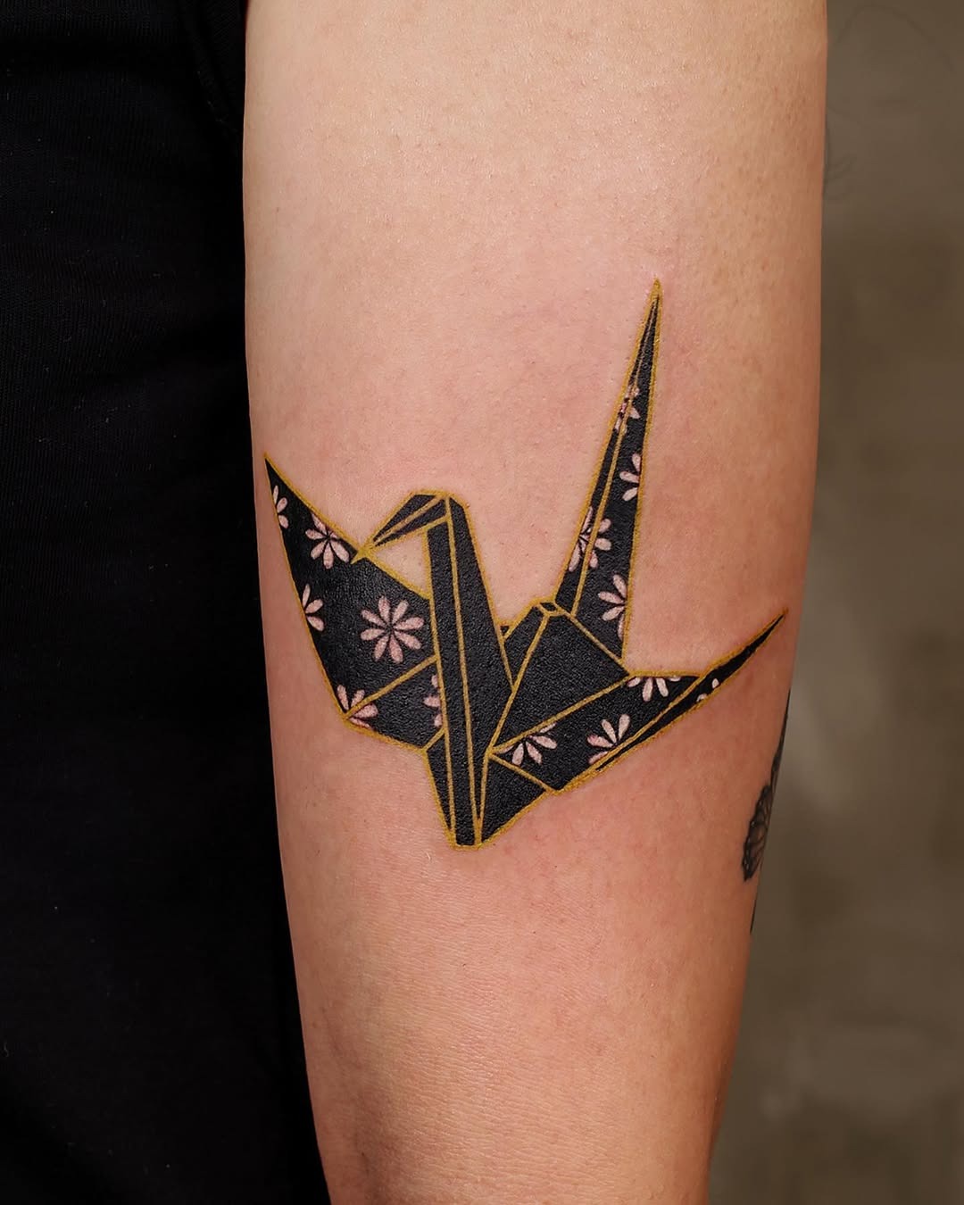 Elegant origami crane tattoo with floral details Tattoo Design